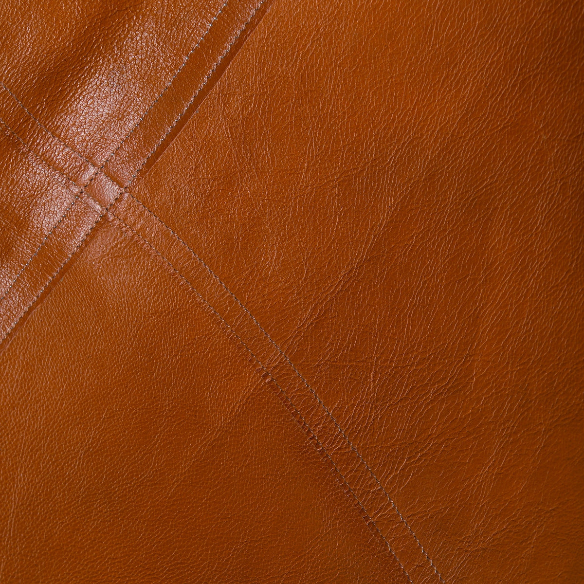 Classy Leather Bags Still Corner Chair with plush upholstery and wooden legs, showcasing a stylish modern chair design.