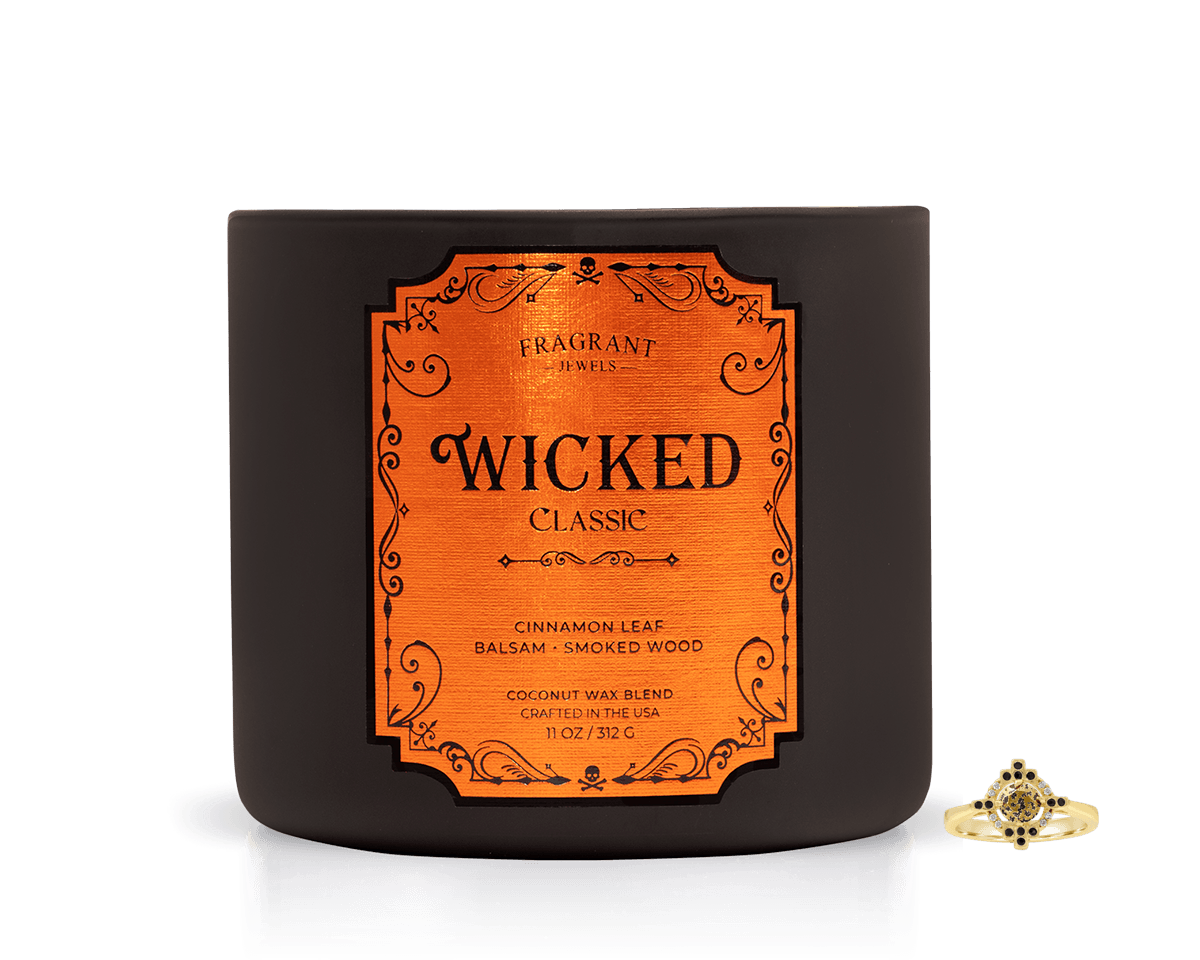 Wicked Classic Jewel Candle - Experience Dark Magic in a dark jar with an orange label, featuring cinnamon leaf and smoked wood.