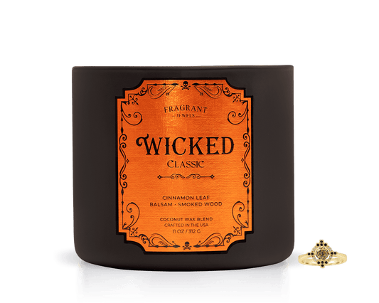 Wicked Classic Jewel Candle - Experience Dark Magic in a dark jar with an orange label, featuring cinnamon leaf and smoked wood.