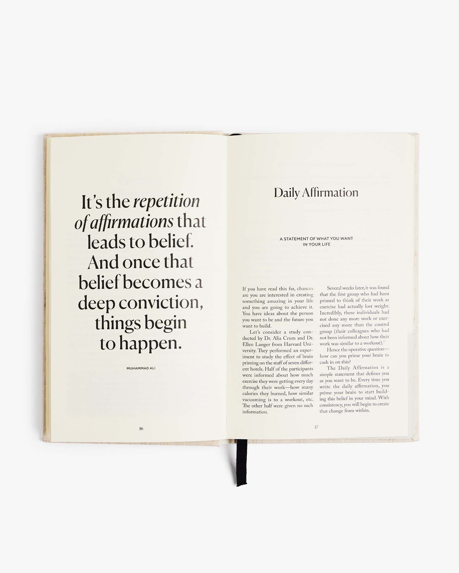 The Five Minute Journal by Intelligent Change in linen cover, featuring a minimalist mindfulness journal with lined pages.