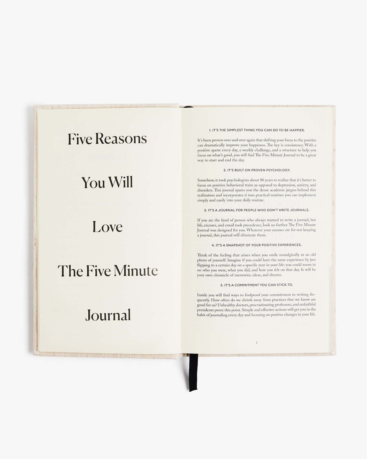 The Five Minute Journal by Intelligent Change in original linen cover, featuring blank pages for daily mindfulness and gratitude reflections.