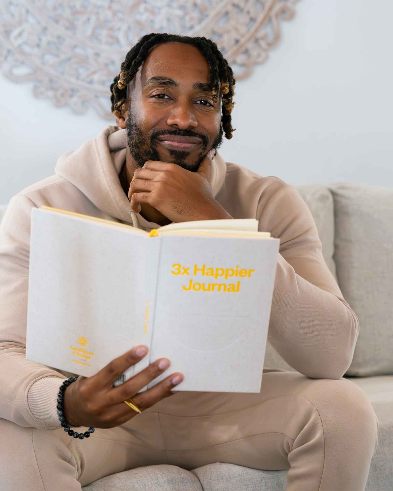 Close-up of the Intelligent Change 3x Happier Journal with a minimalist cover design and lined pages for daily reflections.
