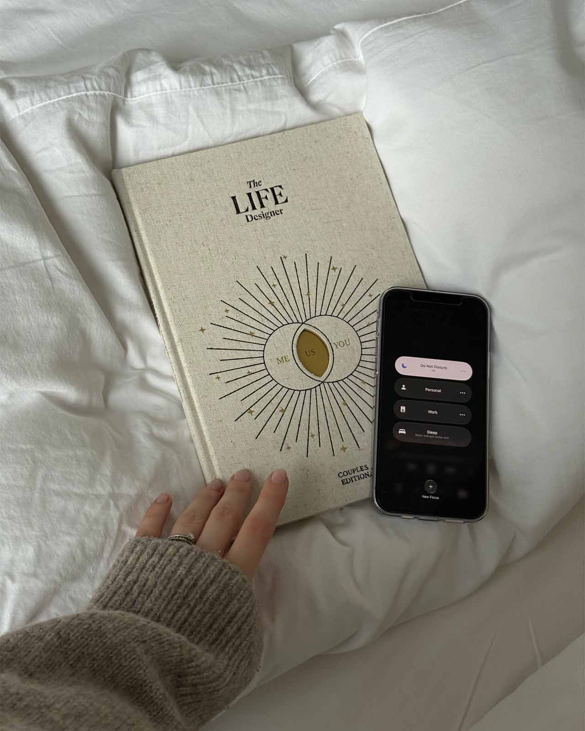 Life Designer Journal for Couples by Intelligent Change, featuring a closed journal with a textured cover and pink accents.