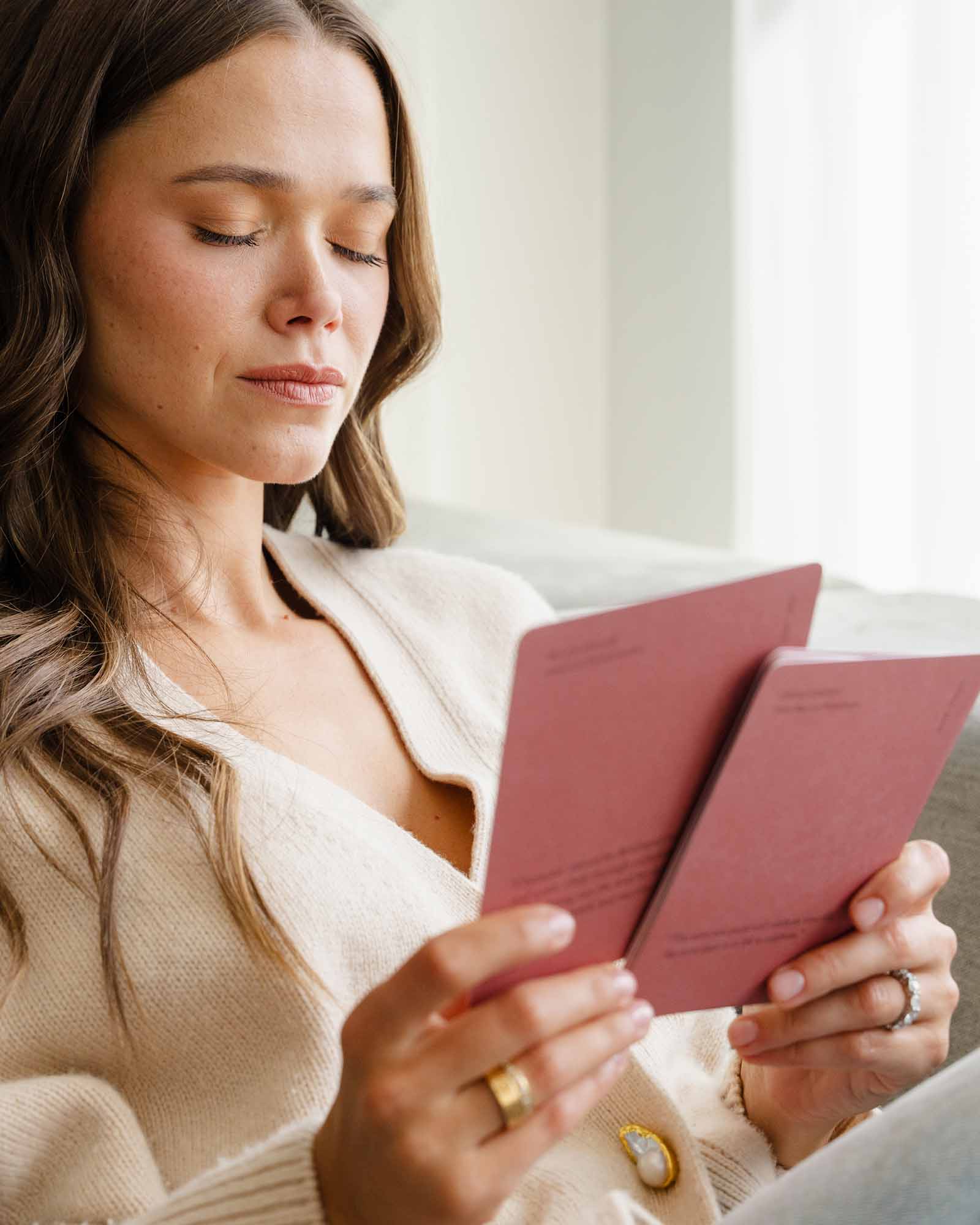 A woman practicing mindful affirmations with a journal, promoting positive thoughts and self-care, by Valeria Lipovetsky for Intelligent Change.