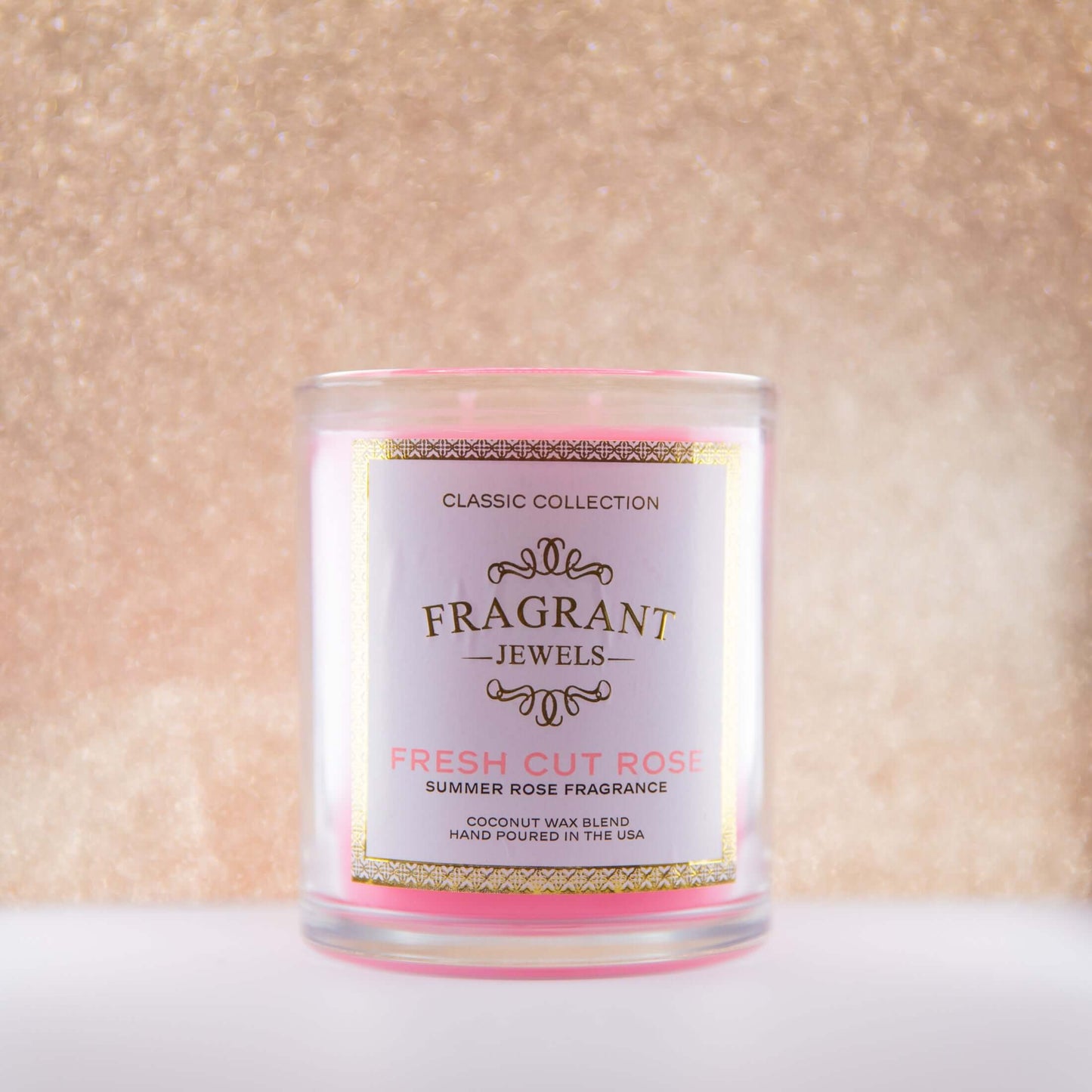 Jewel Candle by Fragrant Jewels with a fresh cut rose scent, featuring a clear glass jar and a decorative rose on top.